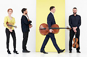 The quartet posed with their instruments